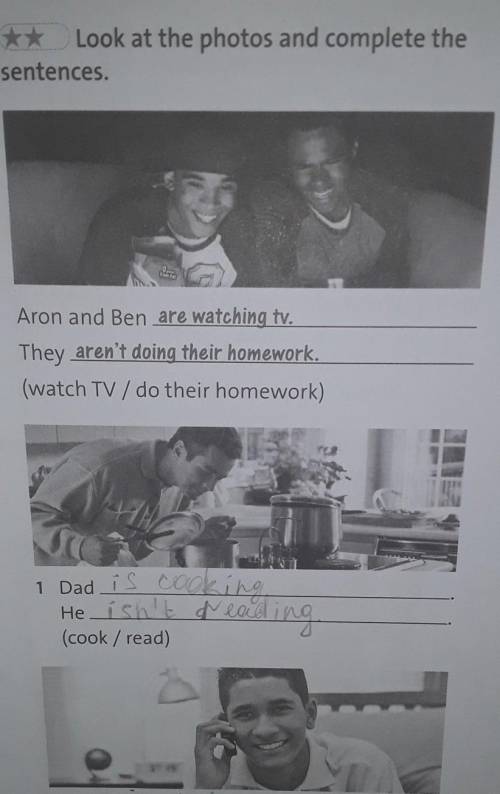 Look at the photos and complete the sentences.Aron and Ben are watching tv.They aren't doing their h